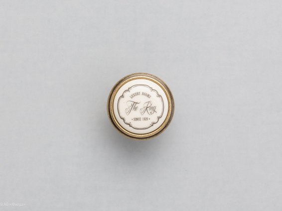 P77 мебельная ручка-кнопка античная бронза с керамической вставкой цвета слоновой кости и надписью The Ring